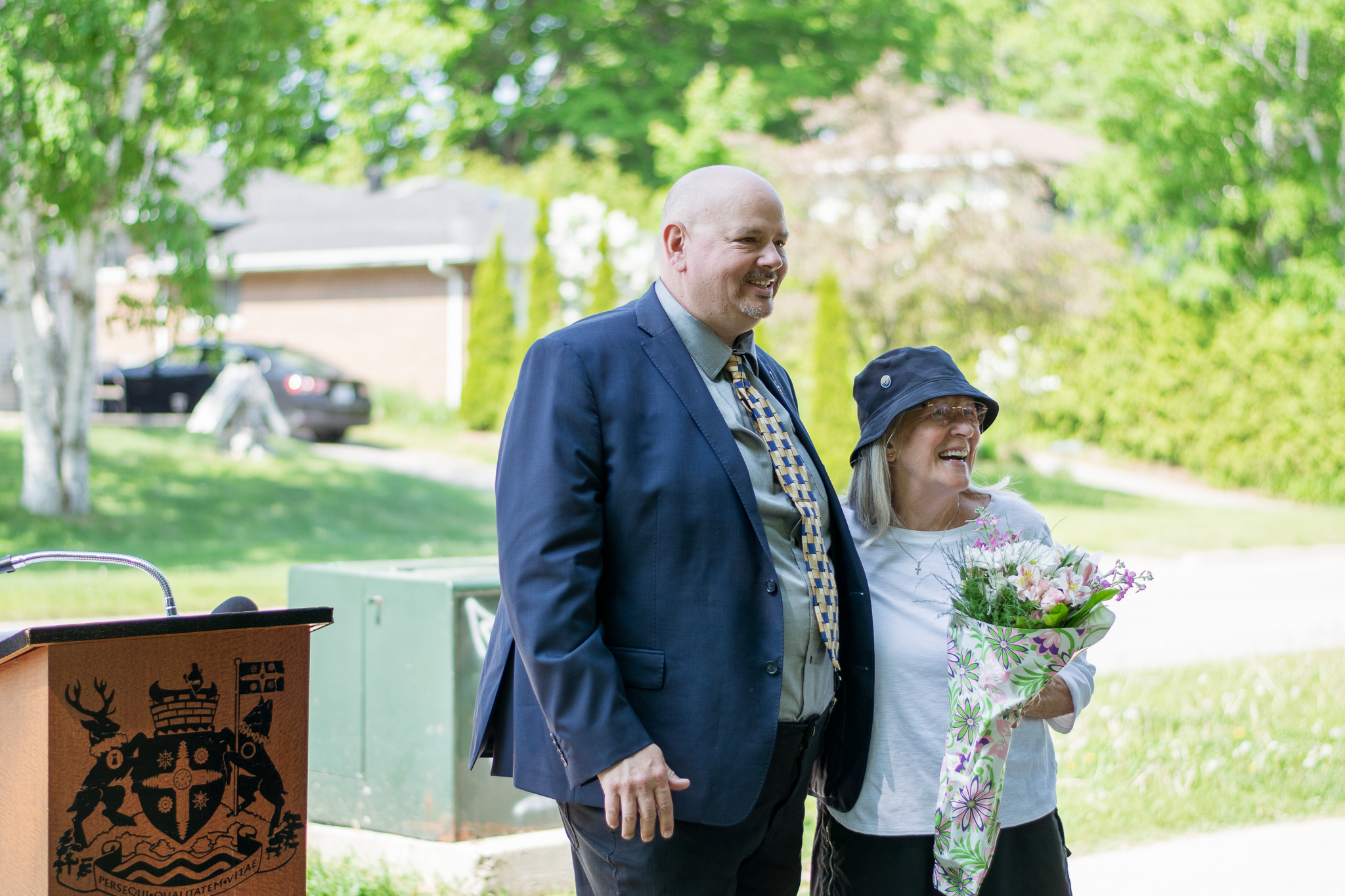 two people standing with flowers